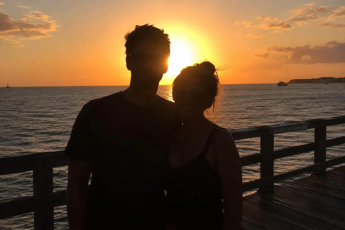 Before: Backlit sunset photo with the couple's faces brightened