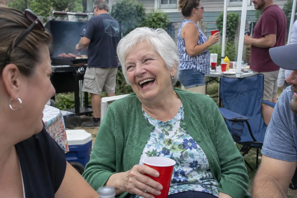 Before: Memorial portrait of an elderly woman created from a busy family barbecue photo