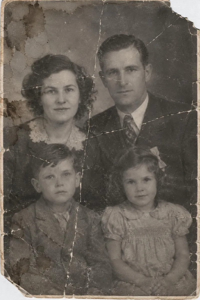Before: Damaged 1940s family portrait restored: creases, tears and stains repaired